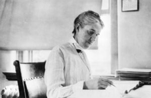 B&W photograph of Henrietta Leavitt working at a desk.
