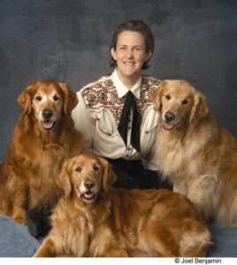White female with three dogs.