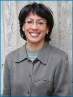 Smiling Black woman with short hair and glasses